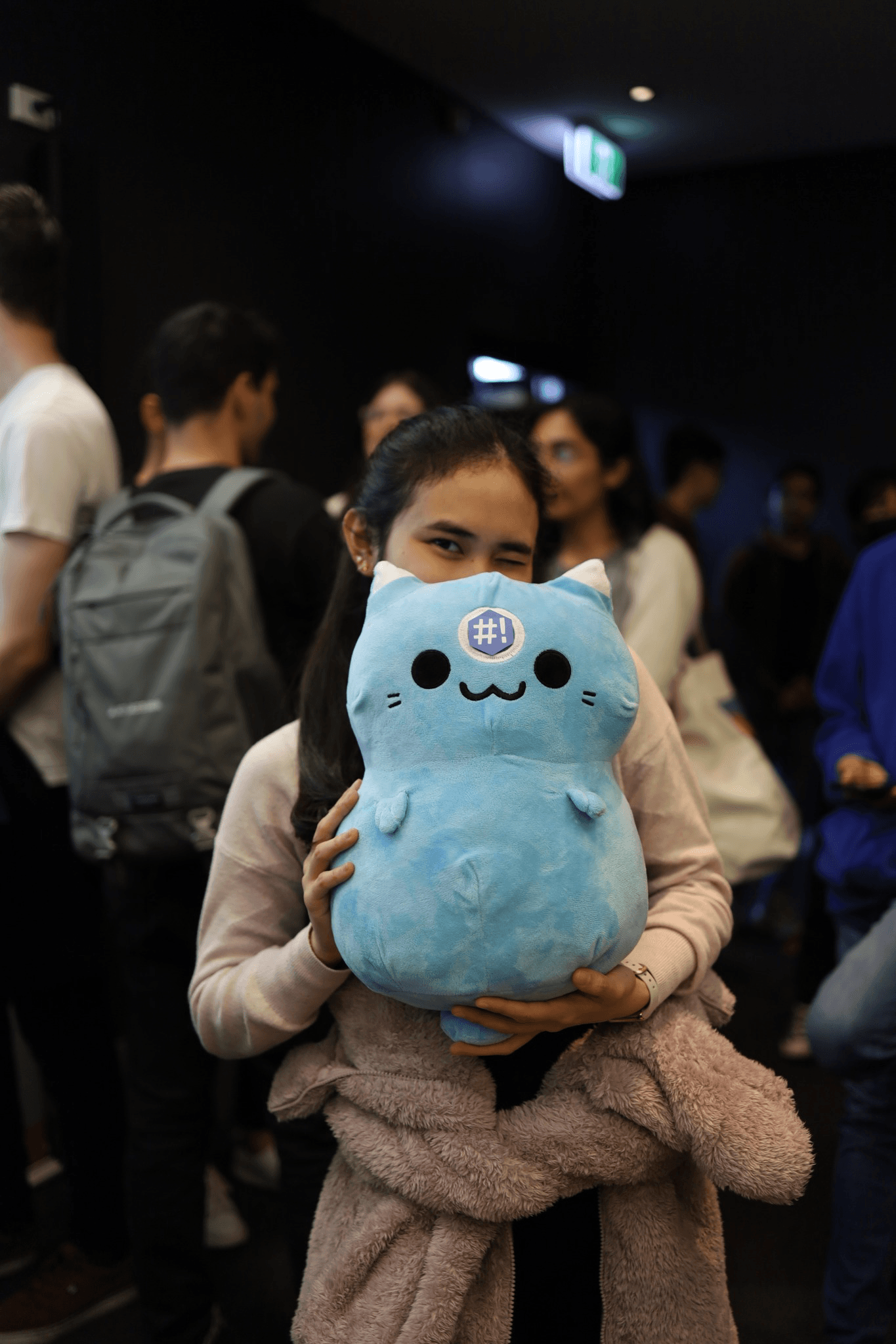 Student holding a Syncs plush toy
